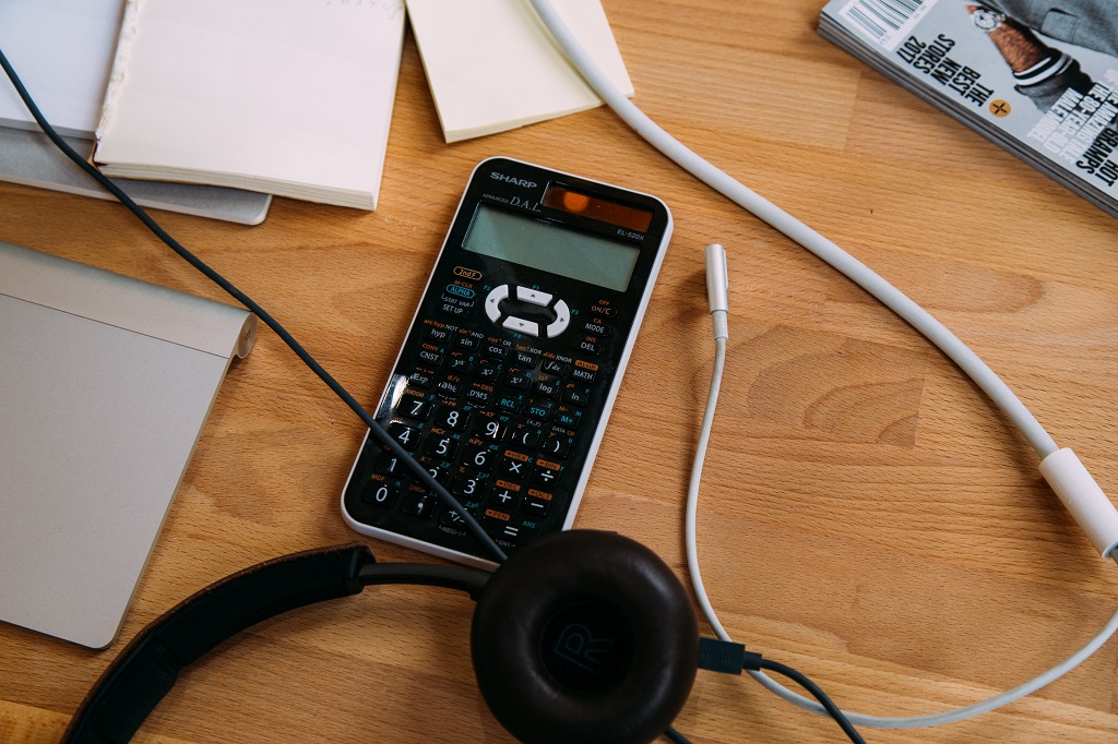 Calculator on the table for math needs with headphones.